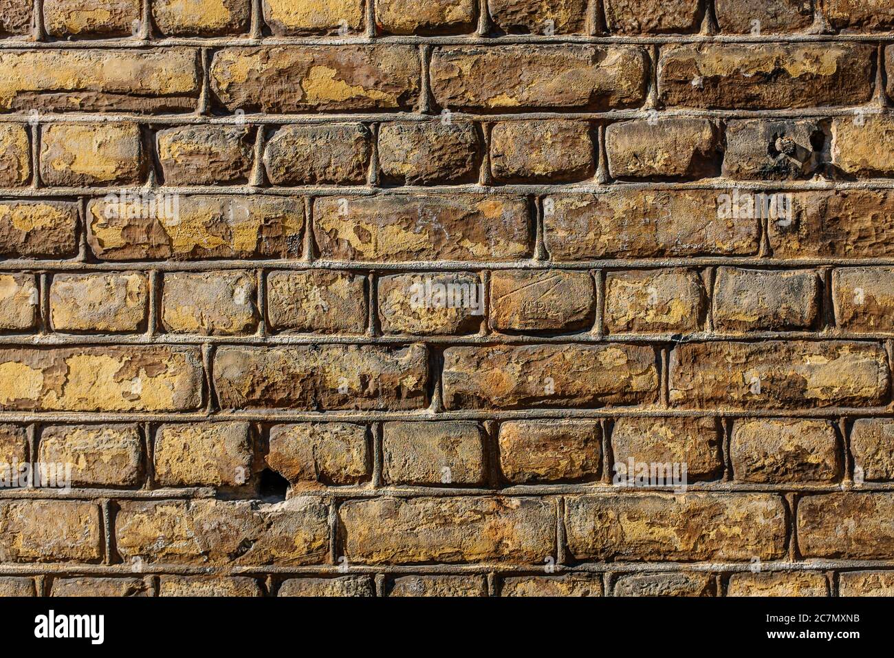 Wall made out of brown rectangular stones Stock Photo