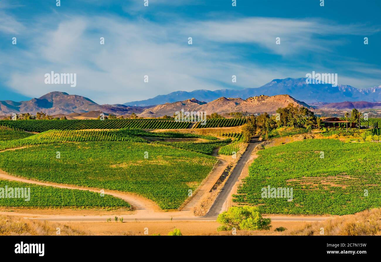 Looking down on the wine country of the Temecula Valley with it's vineyards and hills in front of the mountains in Southern California. Stock Photo