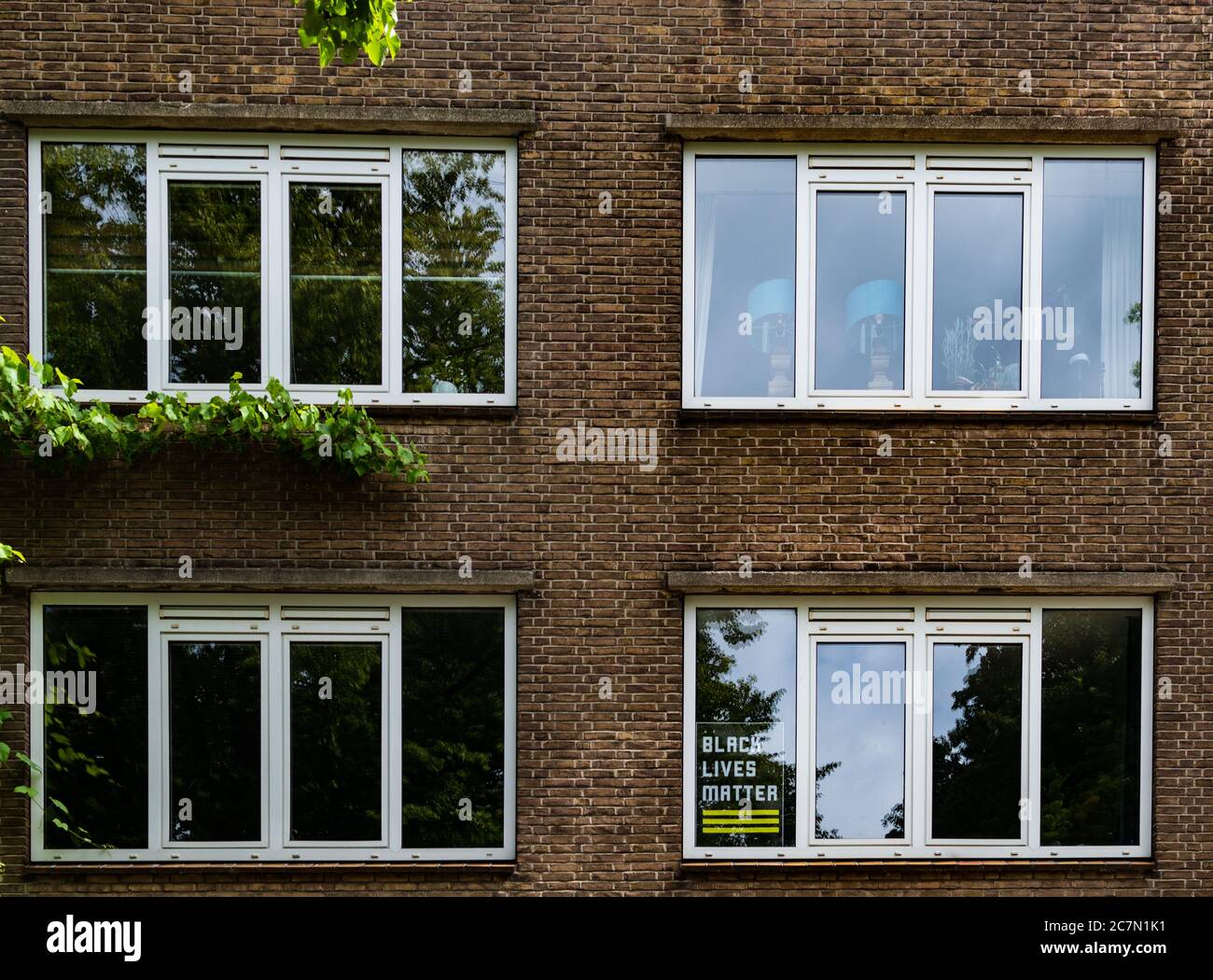 AMSTERDAM, THE NETHERLANDS JULY 1, 2020: Black lives matter poster in a apartment window Stock Photo