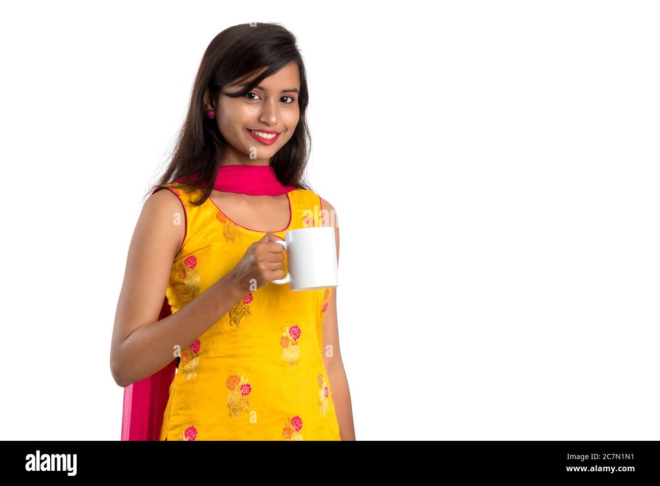 pretty young girl with cup of tea or coffee posing on white background ...