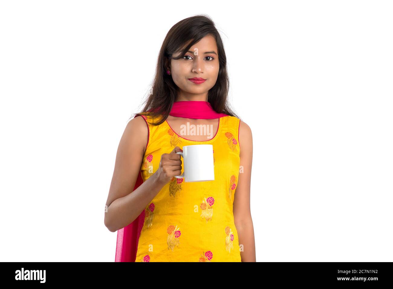 pretty young girl with cup of tea or coffee posing on white background ...