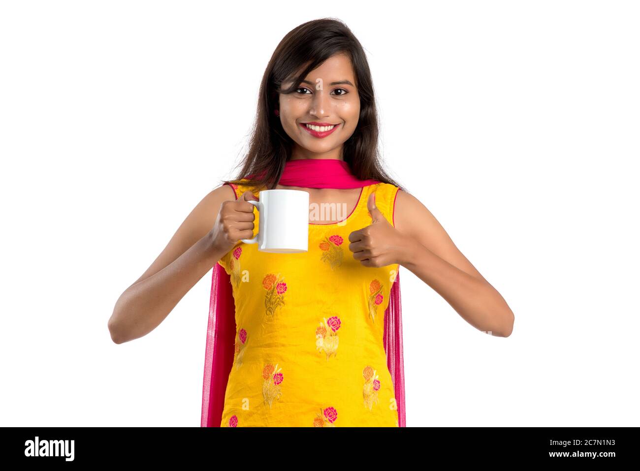 pretty young girl with cup of tea or coffee posing on white background ...