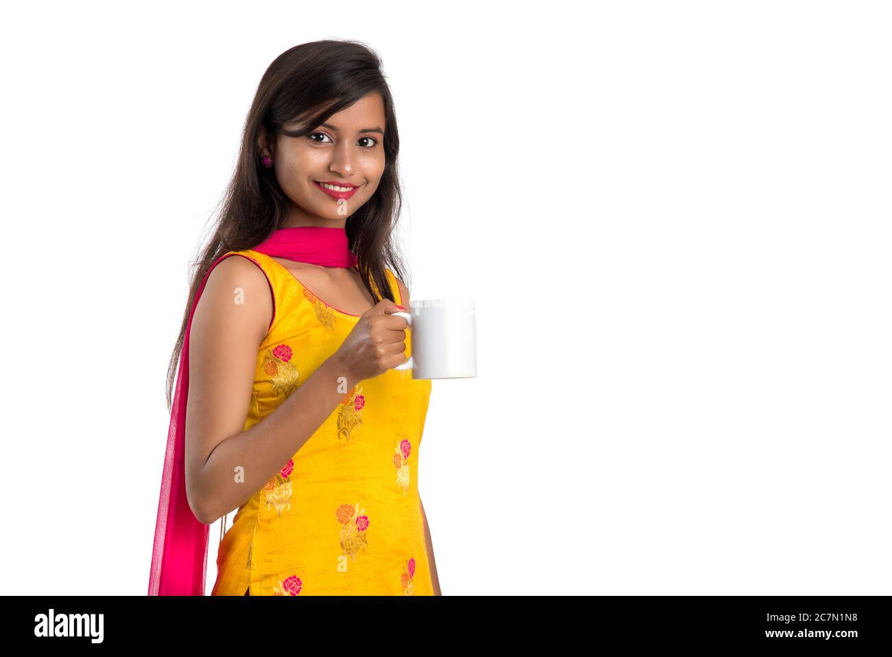 pretty young girl with cup of tea or coffee posing on white background ...