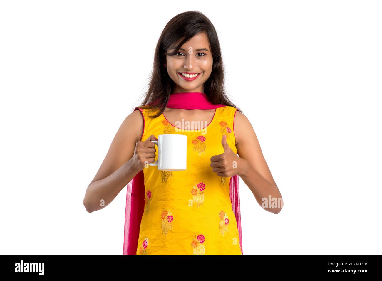 pretty young girl with cup of tea or coffee posing on white background ...
