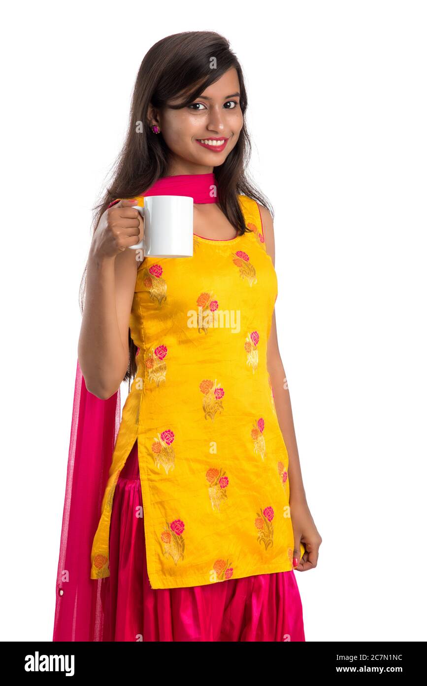 pretty young girl with cup of tea or coffee posing on white background ...