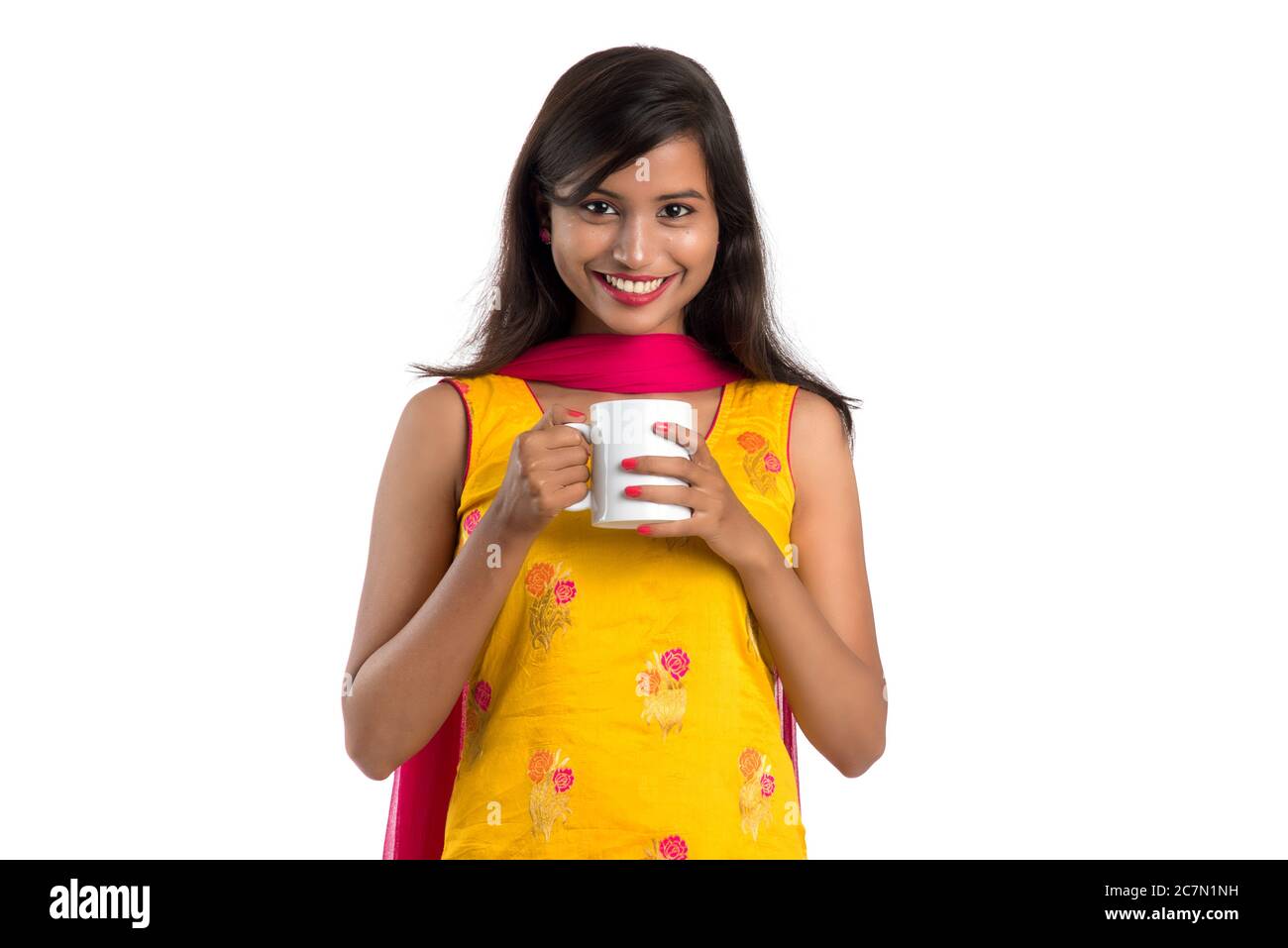 pretty young girl with cup of tea or coffee posing on white background ...