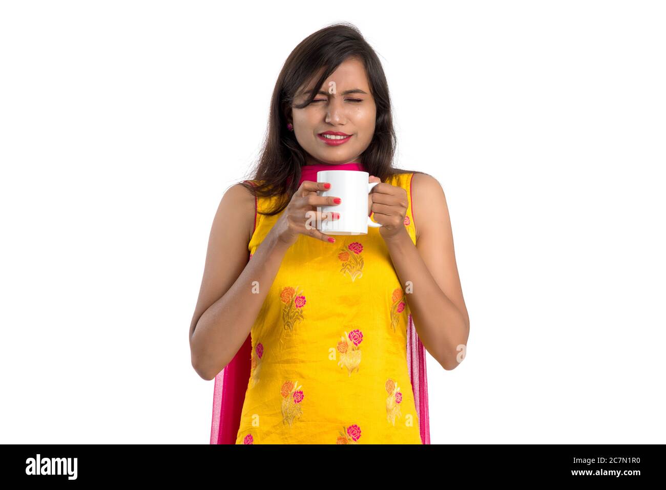 pretty young girl with cup of tea or coffee posing on white background ...