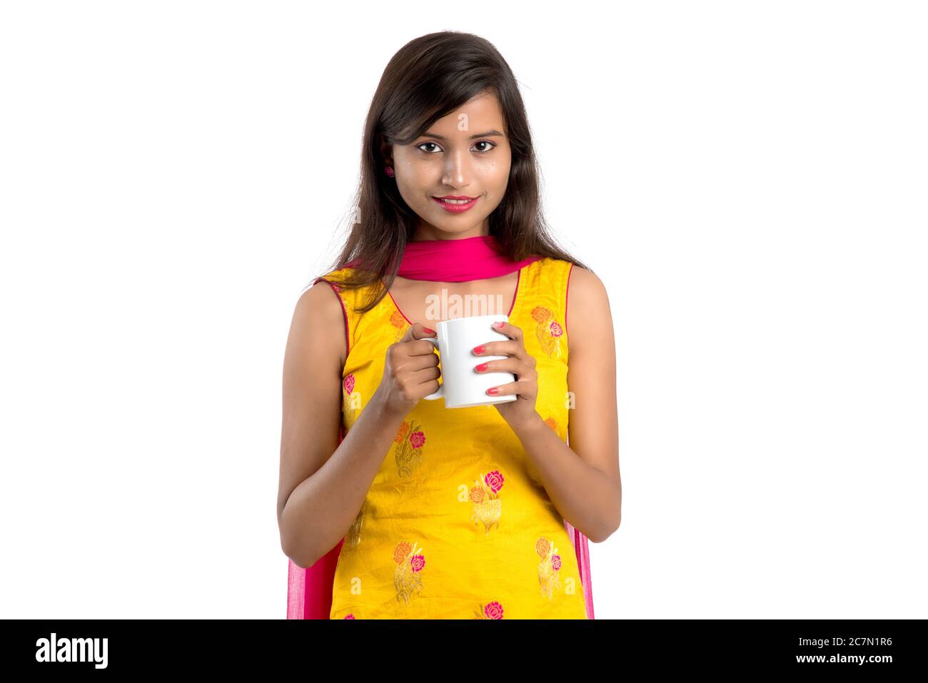 pretty young girl with cup of tea or coffee posing on white background ...
