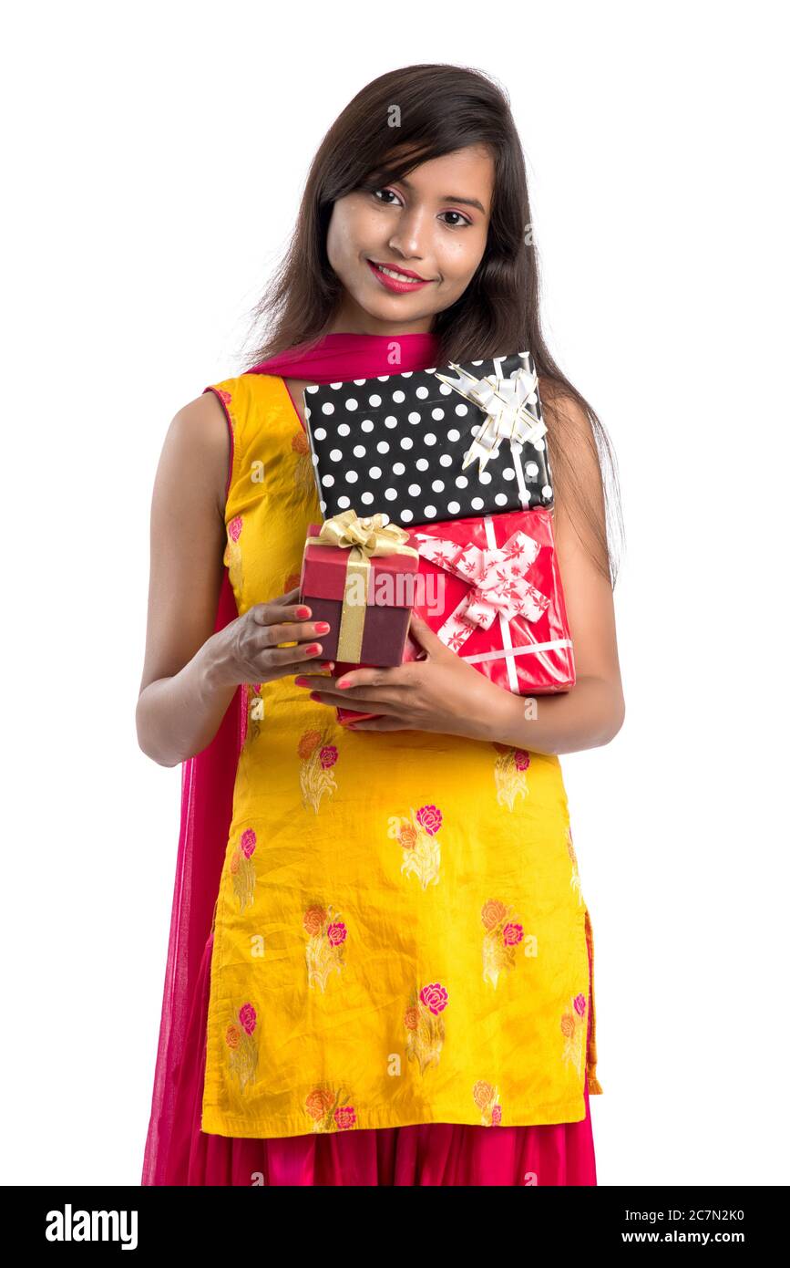 Portrait of young happy smiling Indian Girl holding gift boxes on a ...