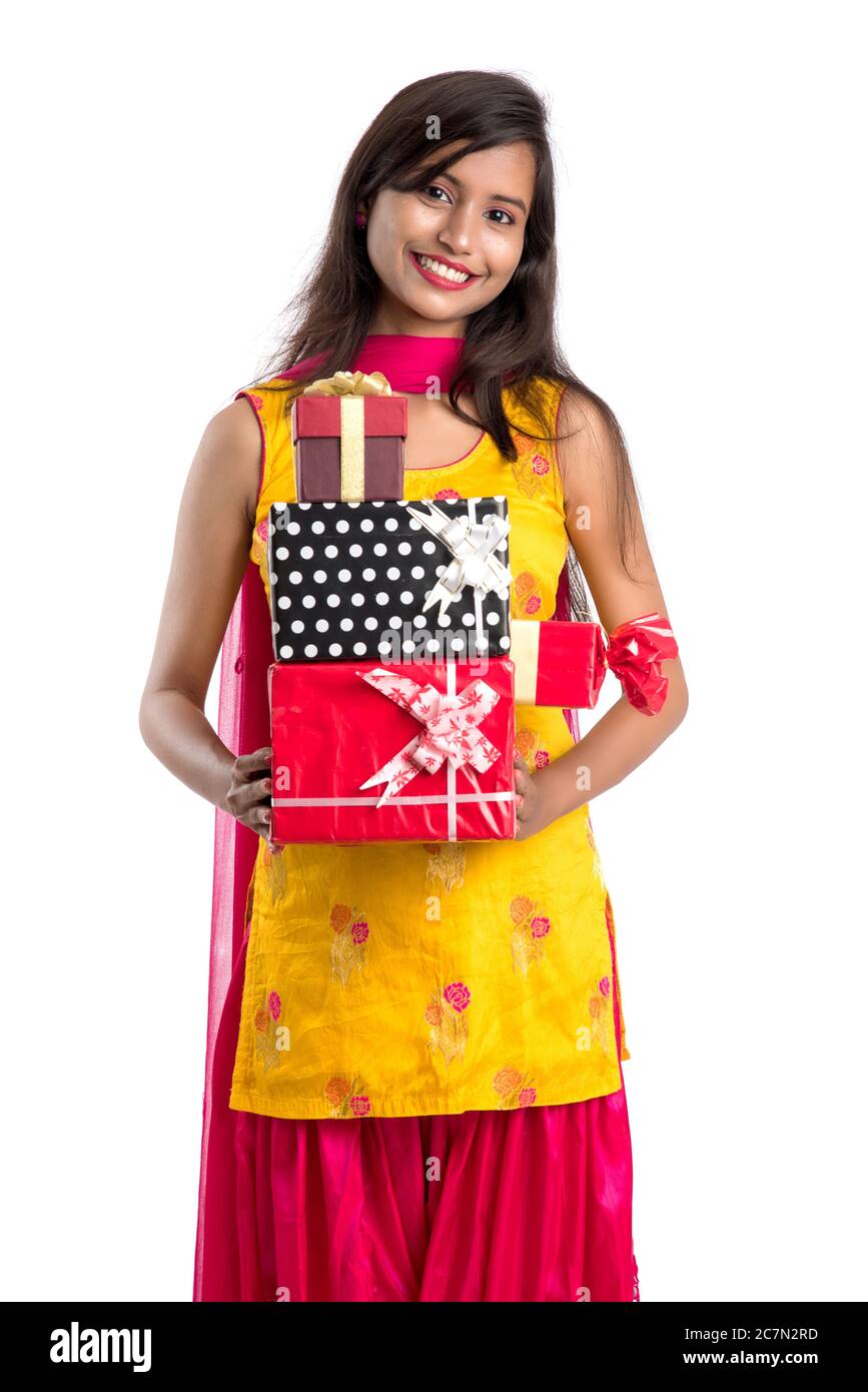 Portrait of young happy smiling Indian Girl holding gift boxes on a ...