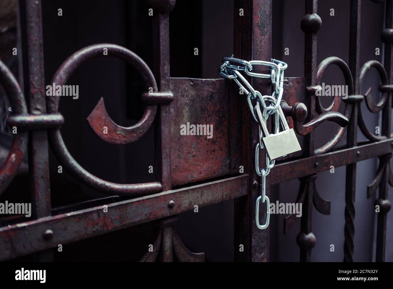 Lock attached to a chain keeping the metal gates closed Stock Photo Alamy