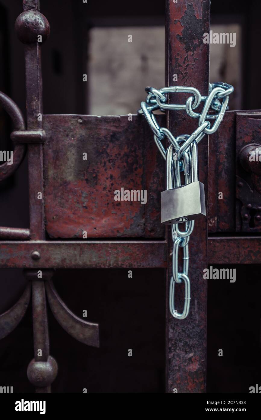 Lock attached to a chain keeping the metal gates closed Stock Photo Alamy
