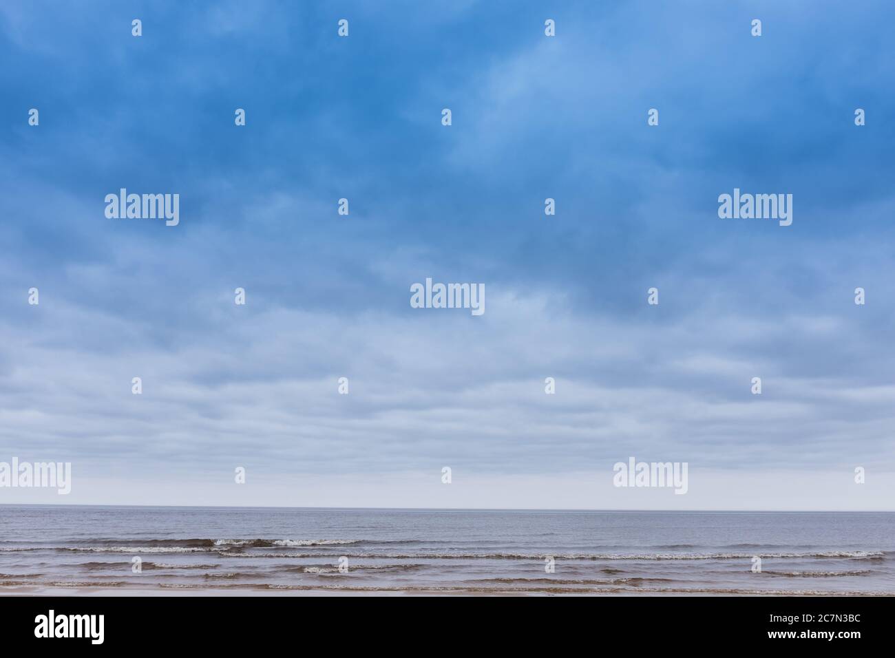Beach under the blue sky full of clouds Stock Photo - Alamy