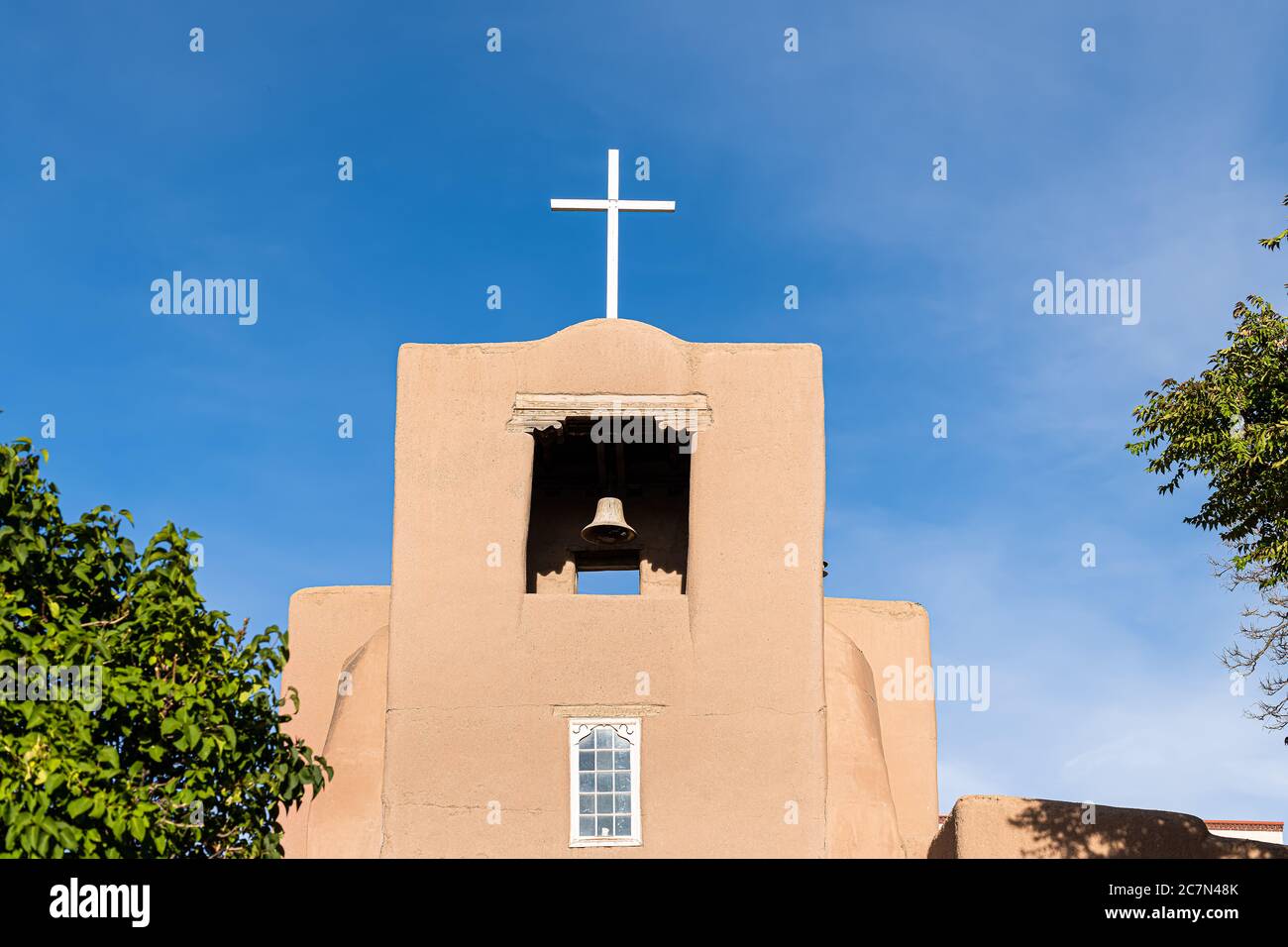 Santa Fe San Miguel Mission chapel oldest church in the United States with adobe pueblan style architecture blue cross and blue sky Stock Photo