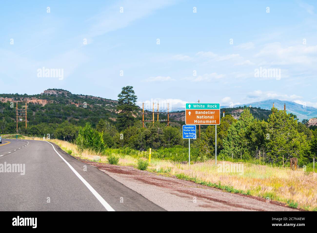 Santa Fe county, New Mexico desert with road highway to White Rock and Bandelier National Monument information sign Stock Photo