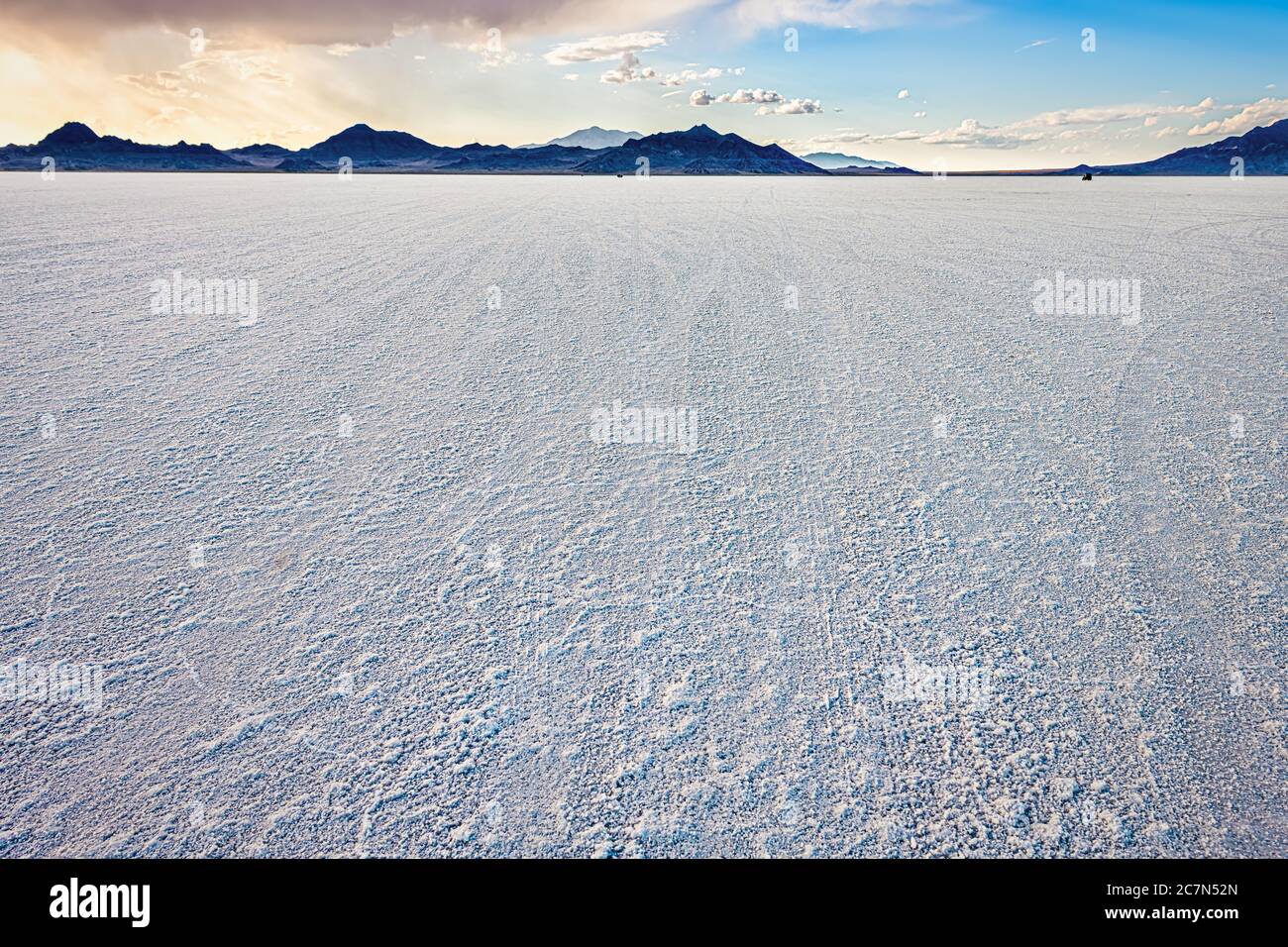 Bonneville Salt Flats wide angle view of texture at foreground and storm clouds near Salt Lake City, Utah and mountain view during sunset with nobody Stock Photo
