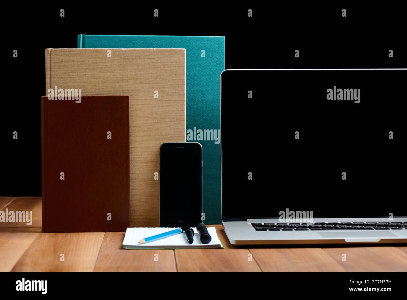 Phone, notebook and books on wooden table Stock Photo
