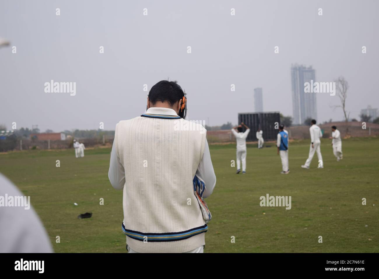 Full length of cricketer playing on field during sunny day, Cricketer on the field in action, Players playing cricket match at field during the day ti Stock Photo