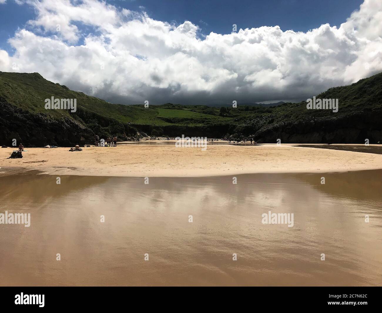 Beautiful beach view seen from the water under the blue sky with fluffy ...