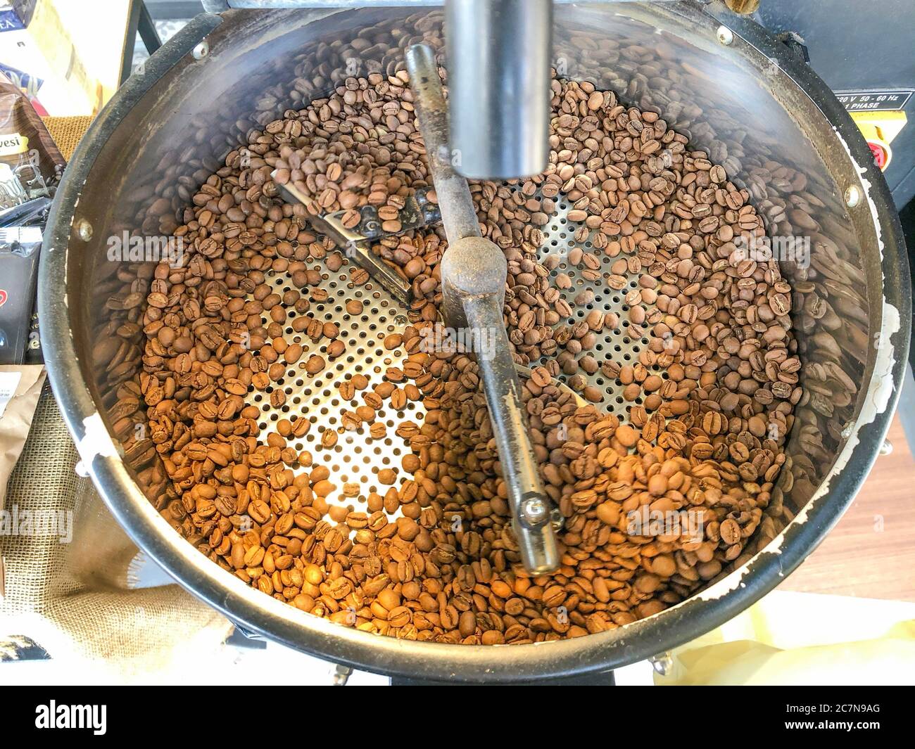 Coffee beans on traditional coffee mill Stock Photo Alamy