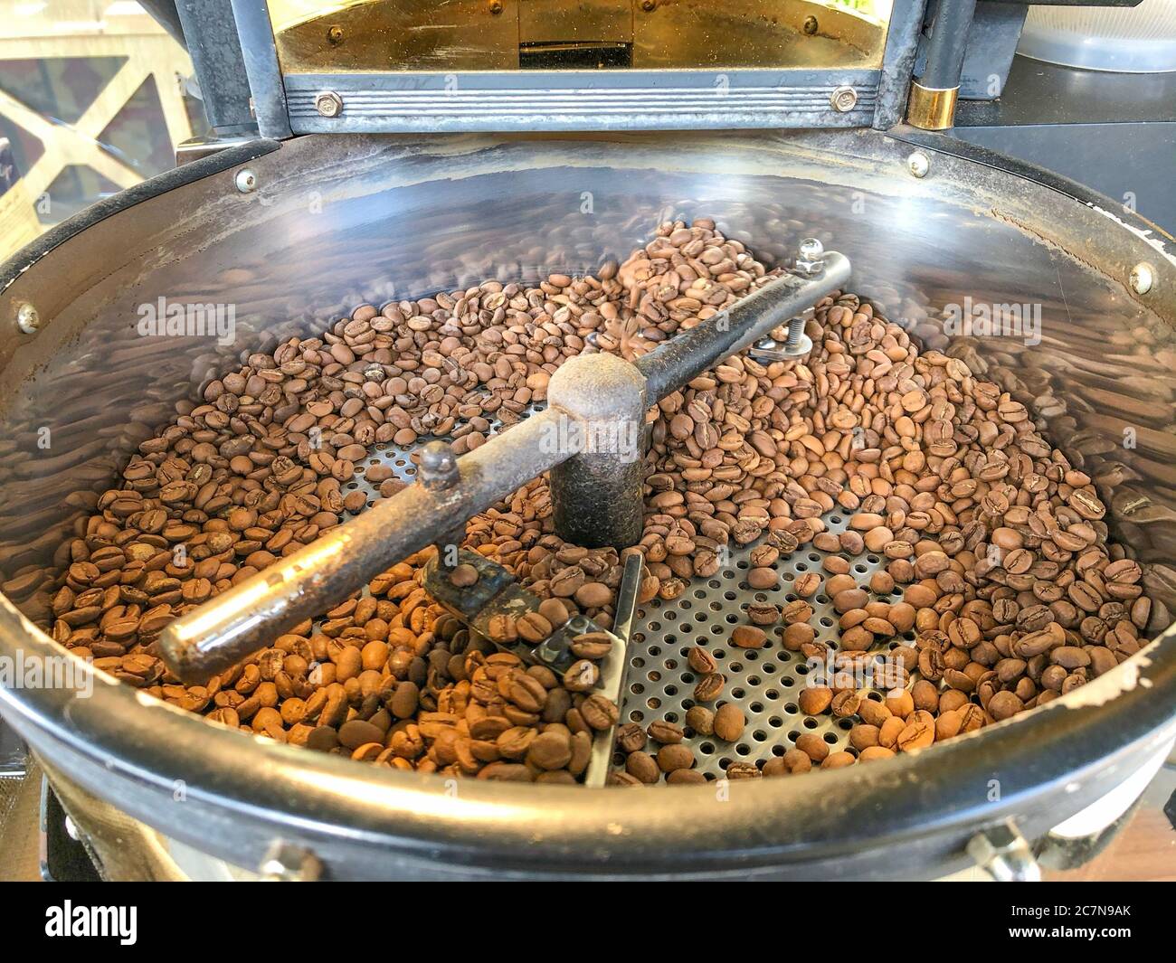 Coffee beans on traditional coffee mill Stock Photo Alamy