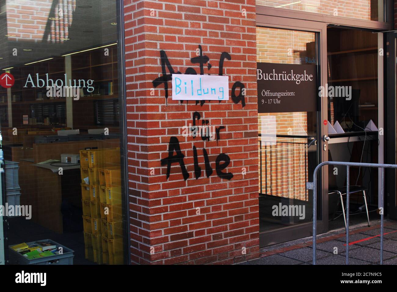 University of Muenster Library with graffiti proclaiming 'Education for everyone' at the book return station which moved outside because of COVID-19. Stock Photo