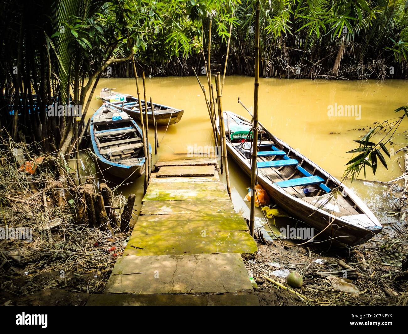 Old wooden boats on muddy water in a forest Stock Photo - Alamy