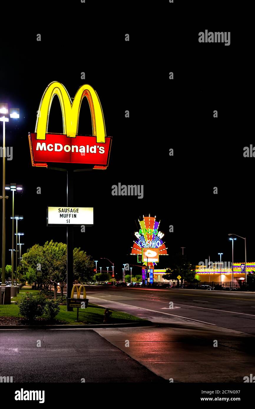 Wendover, USA - July 27, 2019: Nevada city near Utah border with Mcdonald's and famous Rainbow hotel and Casino on road at night illuminated neon ligh Stock Photo