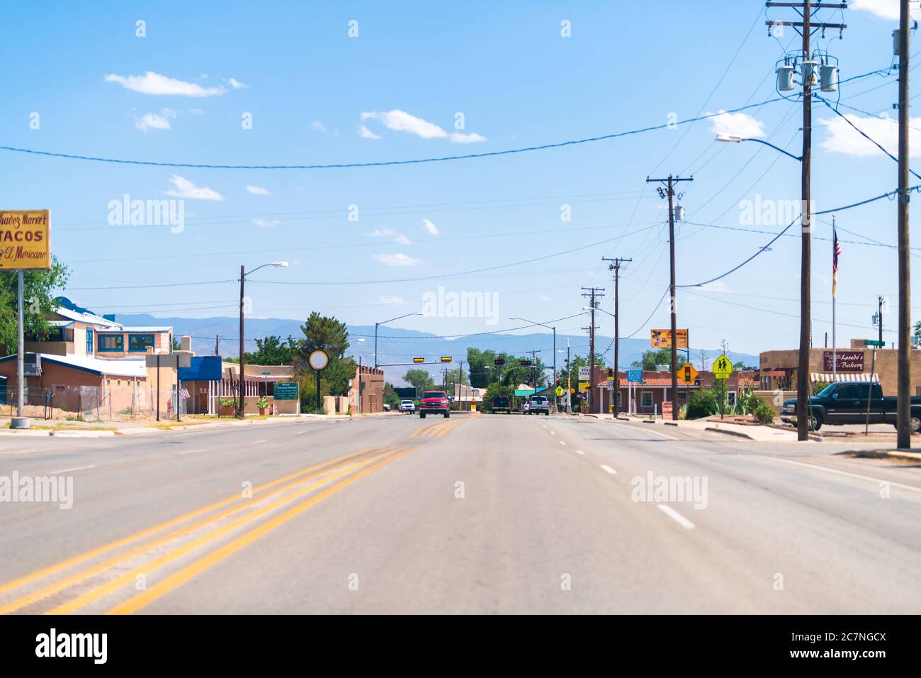 Tularosa, USA - June 8, 2019: New Mexico countryside small city town street road with stores shops buildings and mountains in background Stock Photo