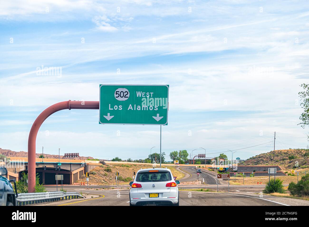 Santa Fe, USA - June 17, 2019: New Mexico desert with cars on road highway sign to Los Alamos driving with street 502 west Stock Photo