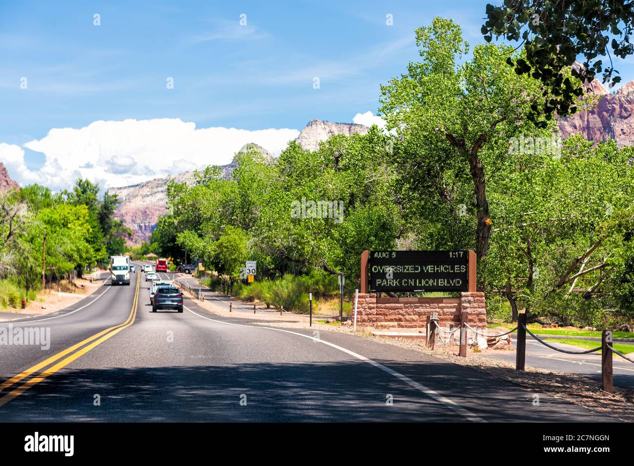 Springdale, USA - August 5, 2019: Zion National Park entrance sign and traffic with parking information on road in Utah and cars in road point of view Stock Photo
