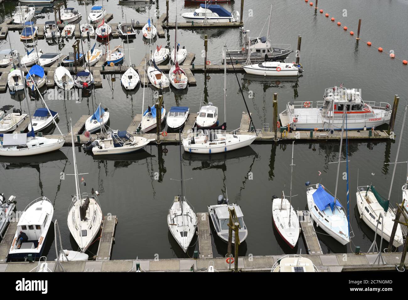 Various sailing and power boats are moored at a marina dock below the Burrard Street Bridge in Vancouver, British Columbia, Canada Stock Photo