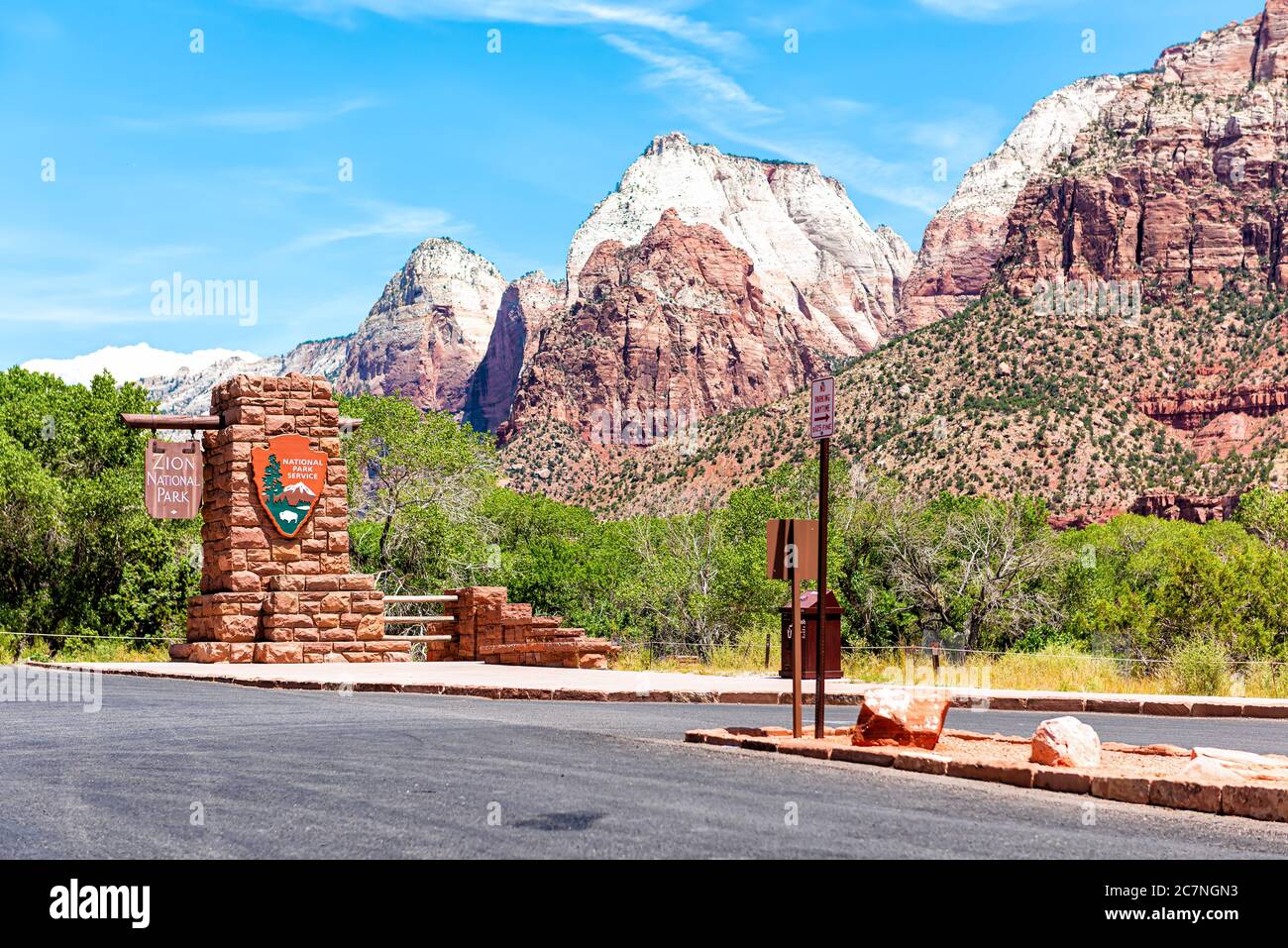 Springdale, USA - August 5, 2019: Zion National Park entrance sign welcome on road in Utah and cliff rock formations Stock Photo