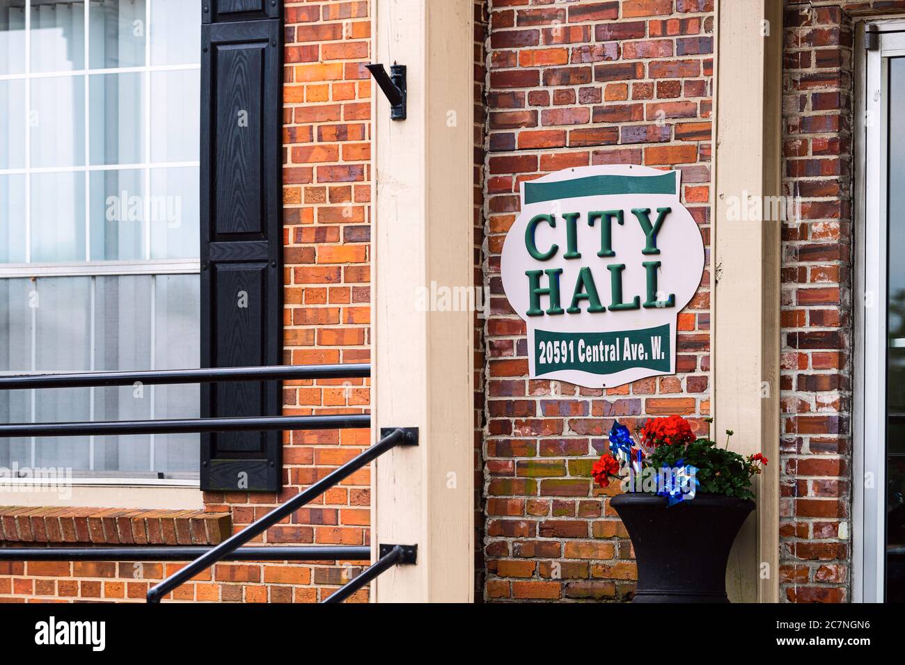 Blountstown, USA - April 26, 2018: Small town city hall sign on central avenue with flowers and historic brick building exterior entrance in Florida Stock Photo