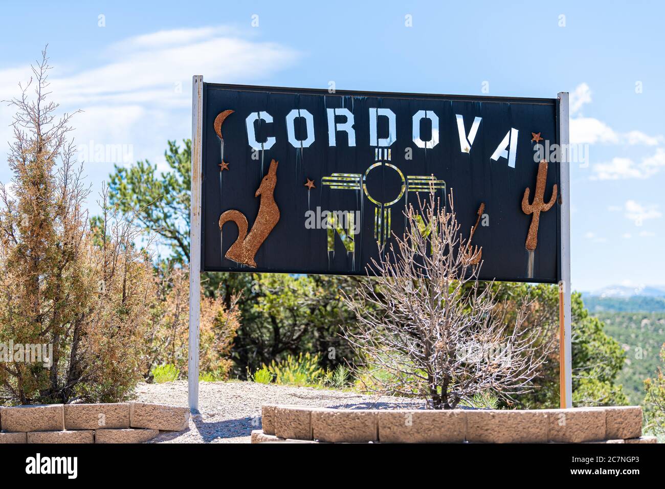 Cordova, USA - June 19, 2019: Scenic drive during summer at High Road to Taos famous trip near Santa Fe and Chimayo with welcome entrance sign to town Stock Photo