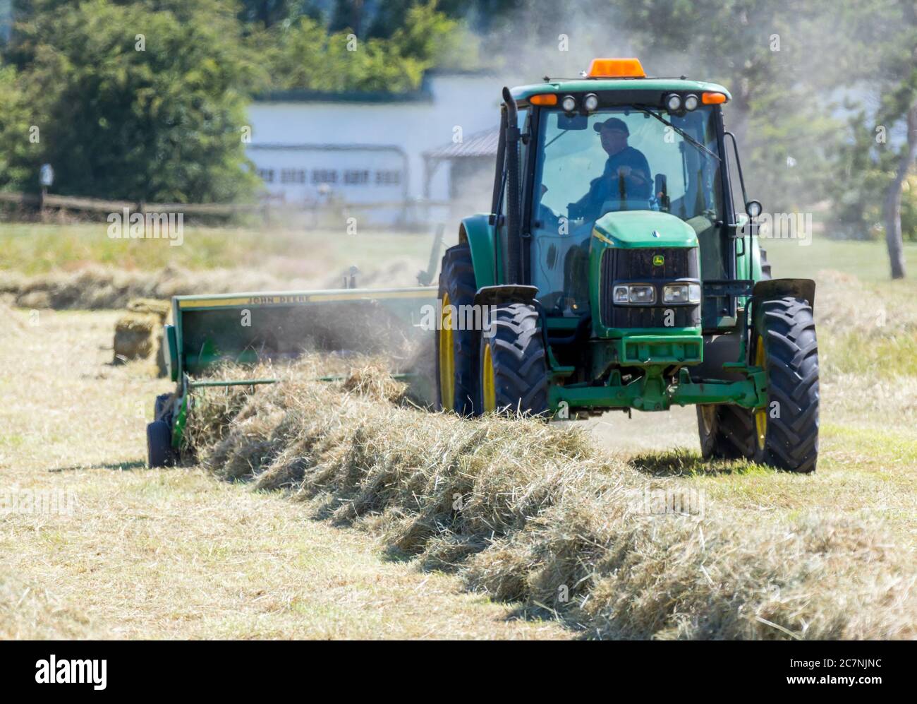Victoria B.C. Canada June 25/2020; A farmer uses tractors and other
