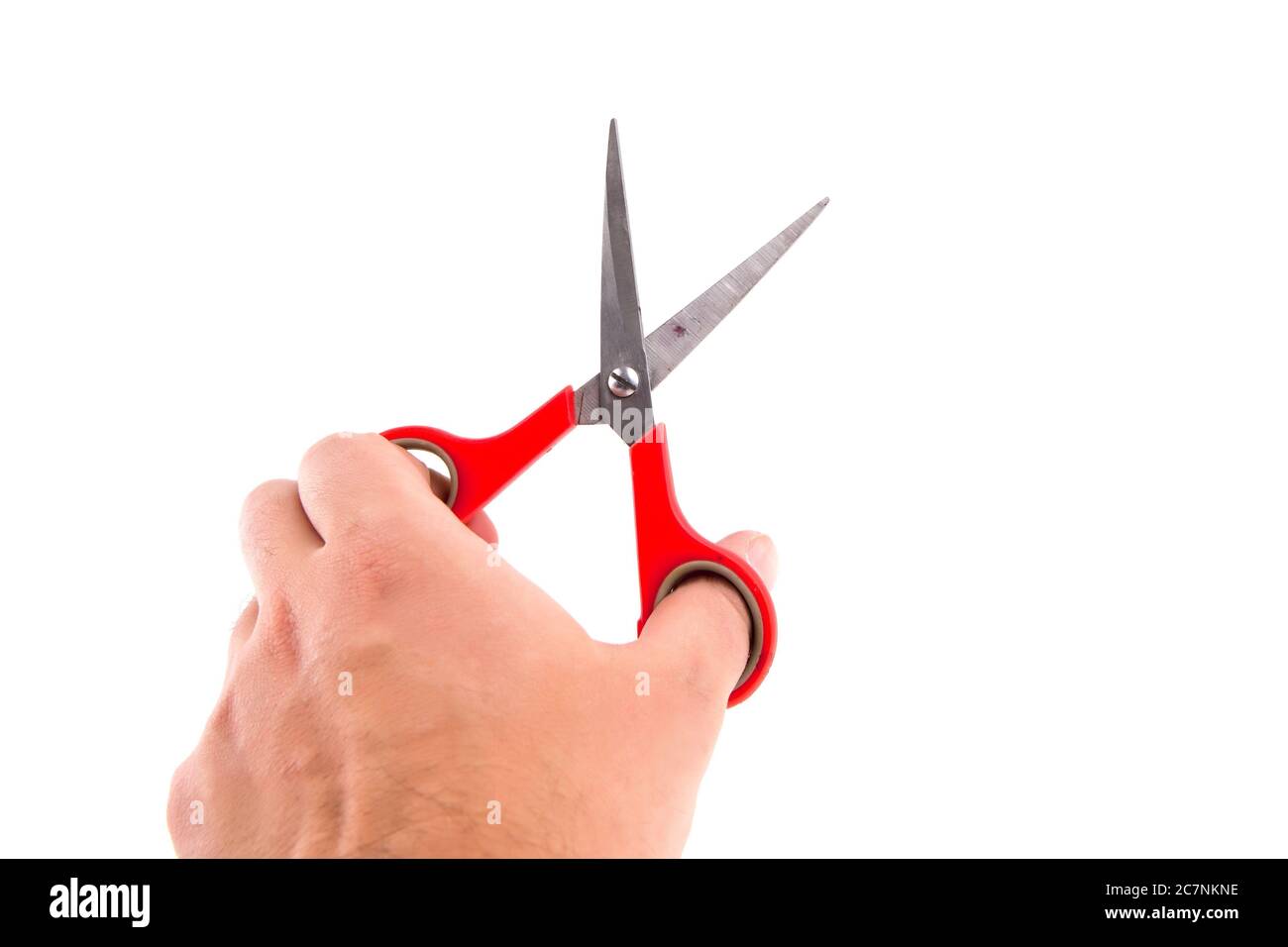 Close-up shot of an isolated mans hand holding red scissors Stock Photo