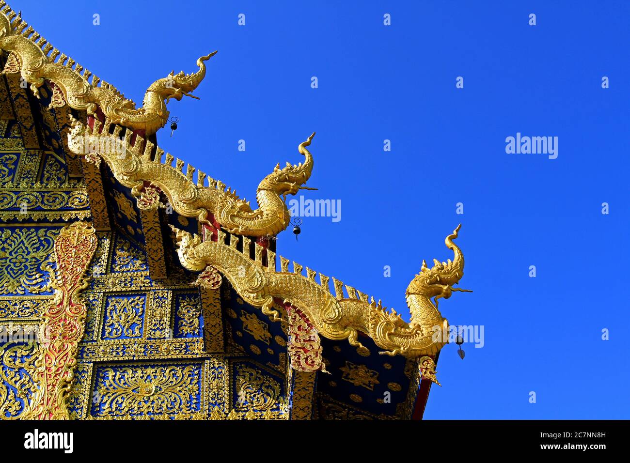 Roof decorated with golden dragons of a building of asian architecture ...