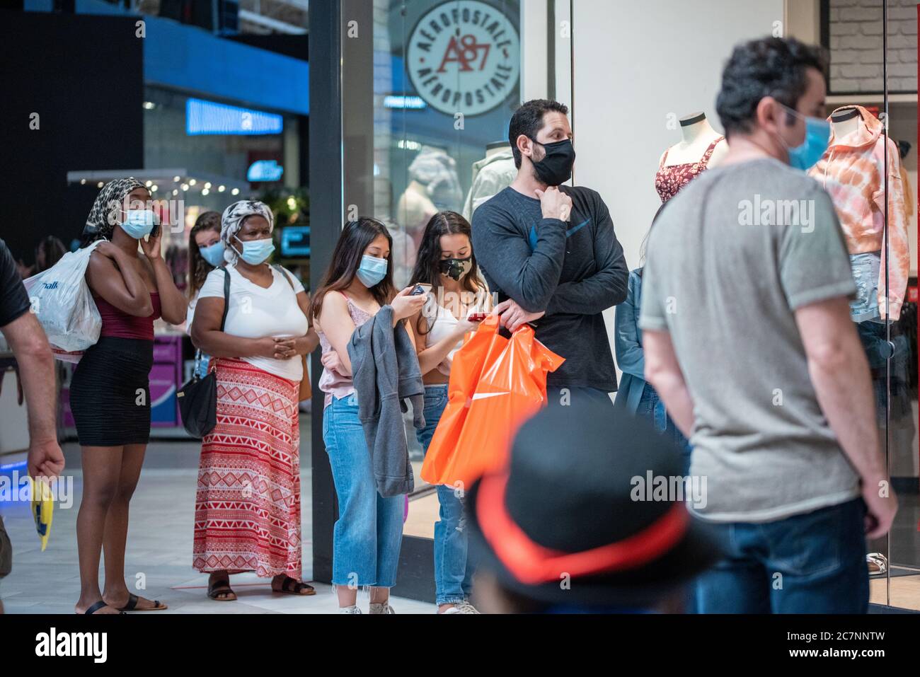 Sunrise, Florida, USA. 18th July, 2020. Shoppers line up to get into a store at Sawgrass Mills Mall in Florida despite record high number of new Covid-19 cases in the state this week Credit: Orit Ben-Ezzer/ZUMA Wire/Alamy Live News Stock Photo