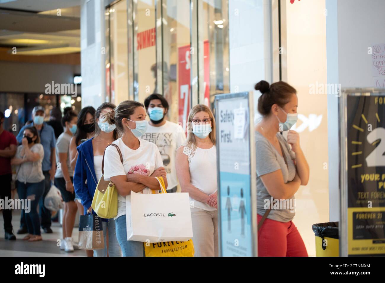 Sunrise, Florida, USA. 18th July, 2020. Shoppers line up to get into a store at Sawgrass Mills Mall in Florida despite record high number of new Covid-19 cases in the state this week Credit: Orit Ben-Ezzer/ZUMA Wire/Alamy Live News Stock Photo