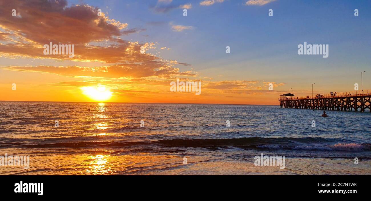 Beautiful sunset captured at the sea with a cloudy sky Stock Photo - Alamy