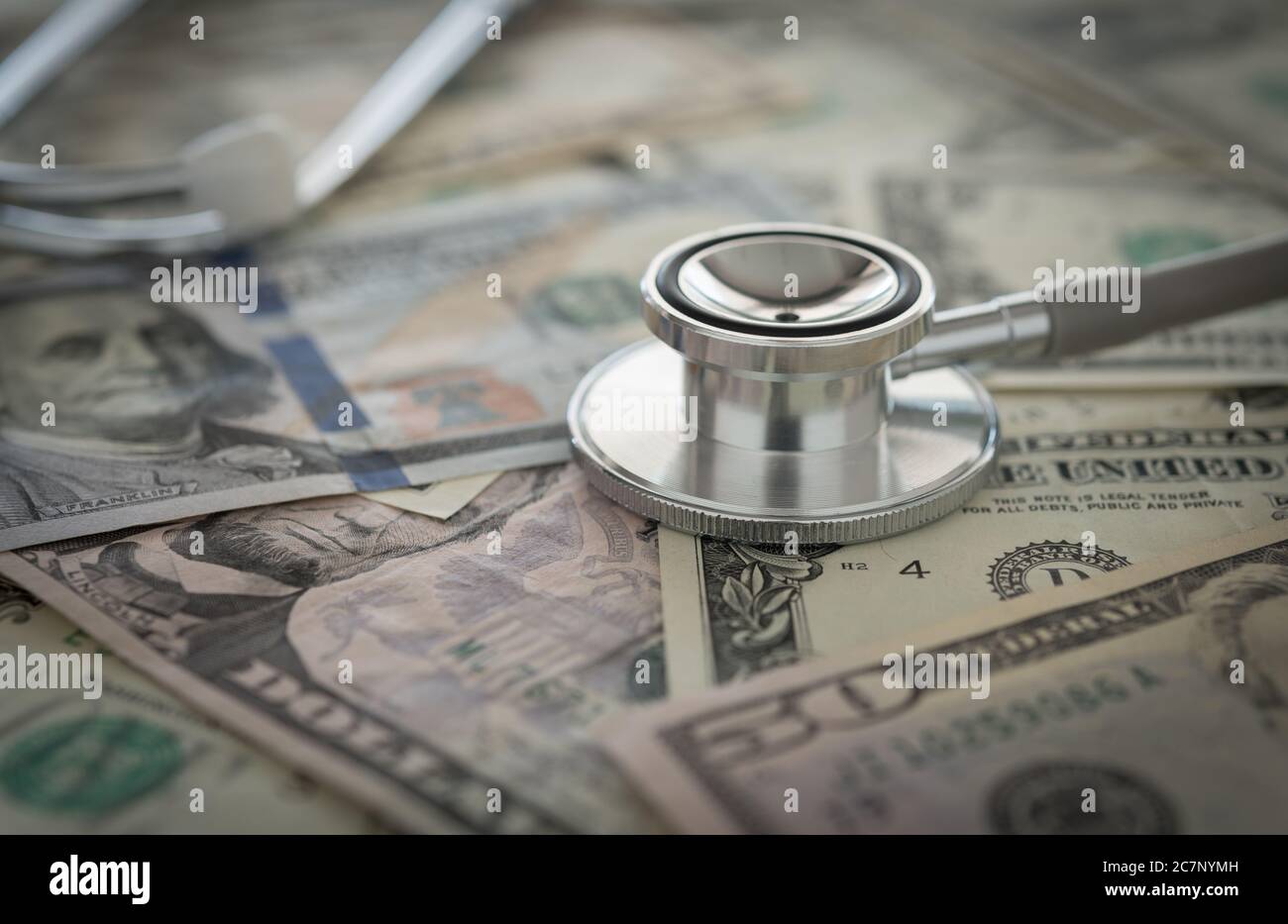 medical cost rising, stethoscope on dollar banknote money. concept of