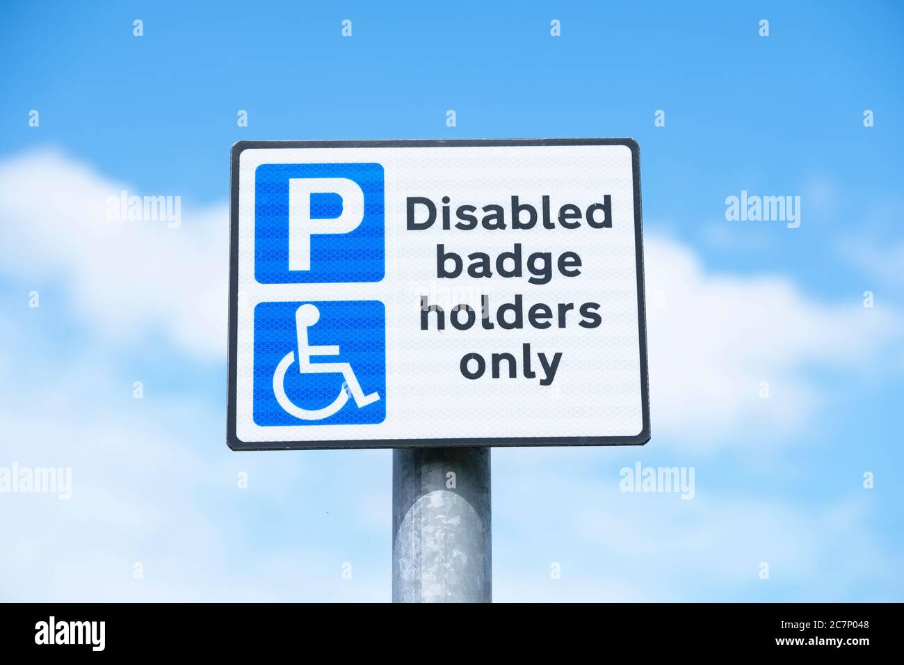 Disabled blue badge holder parking sign for driver Stock Photo Alamy