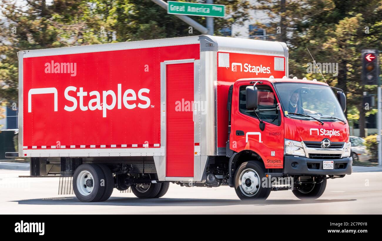 July 16, 2020 Santa Clara / CA / USA - Staples truck driving on a street in San Francisco Bay Area; Staples Inc. is a private American office retail c Stock Photo