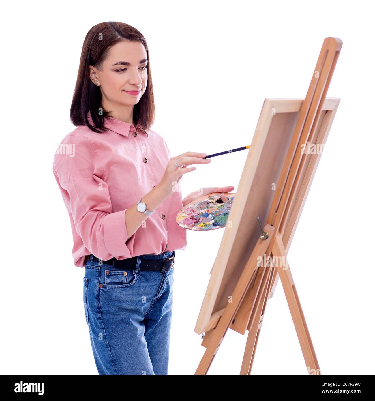 portrait of young woman artist with easel, palette and paint brush ...