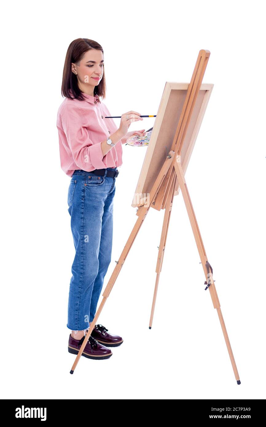 full length portrait of young woman artist with easel, palette and ...