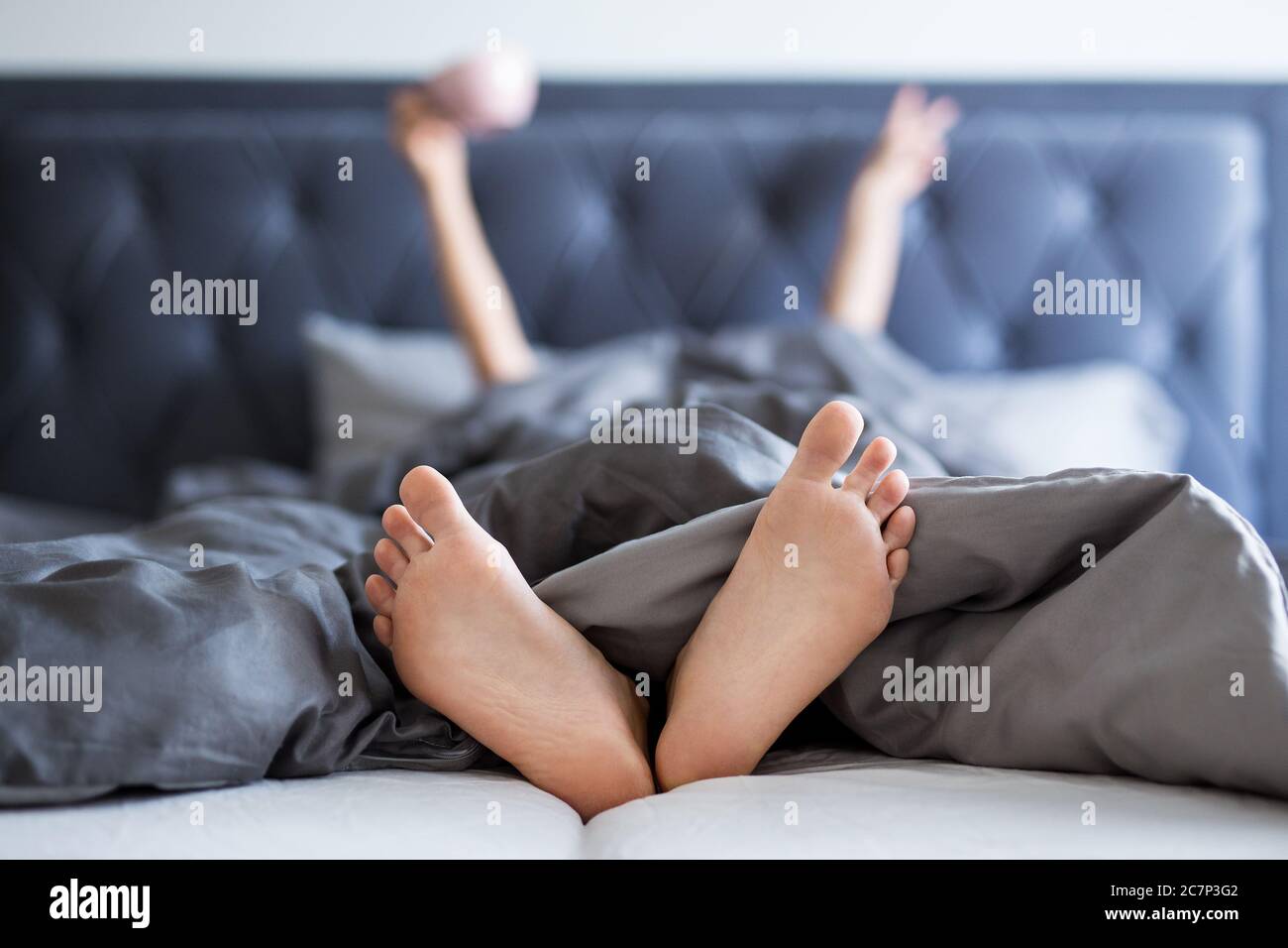 good morning concept female hands and legs sticking out from the