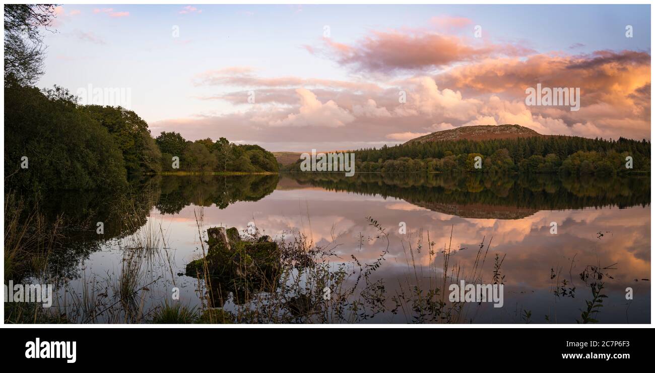 A cloudy sunset over Burrator Reservoir with Sheepstor in the distance Stock Photo