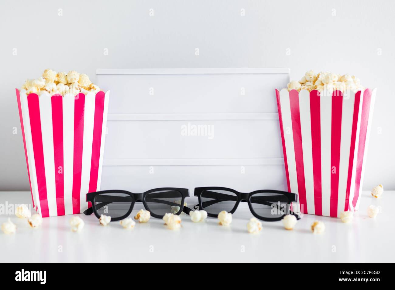 cinema concept - red striped boxes with popcorn, 3d glasses, blank light box with copy space Stock Photo