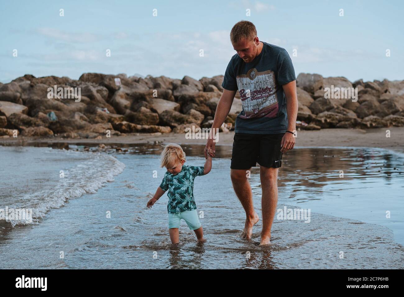Blonde toddler on the beach in Lyme Regis, Dorest, UK Stock Photo